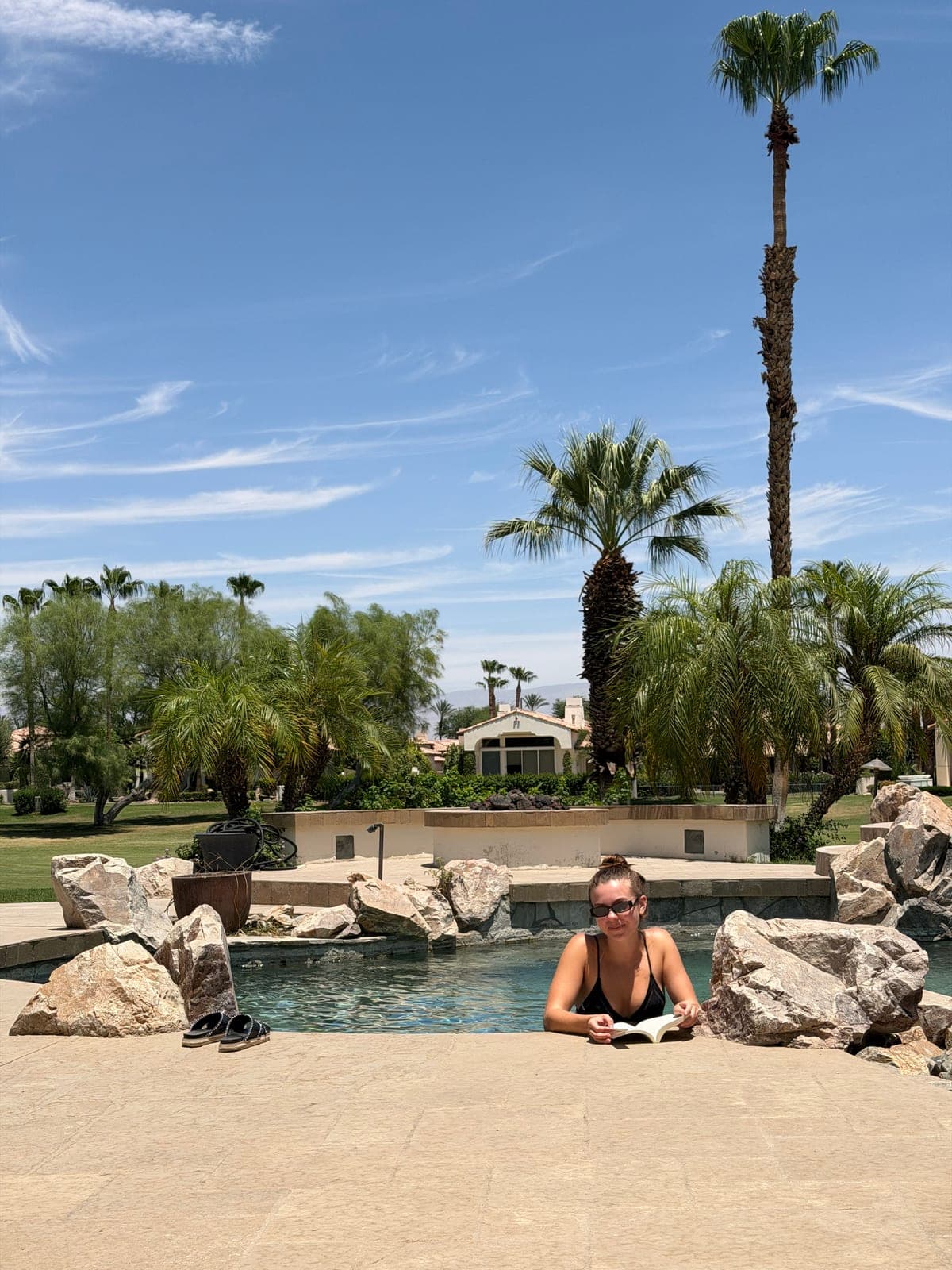 Lounging by the pool beneath the palms